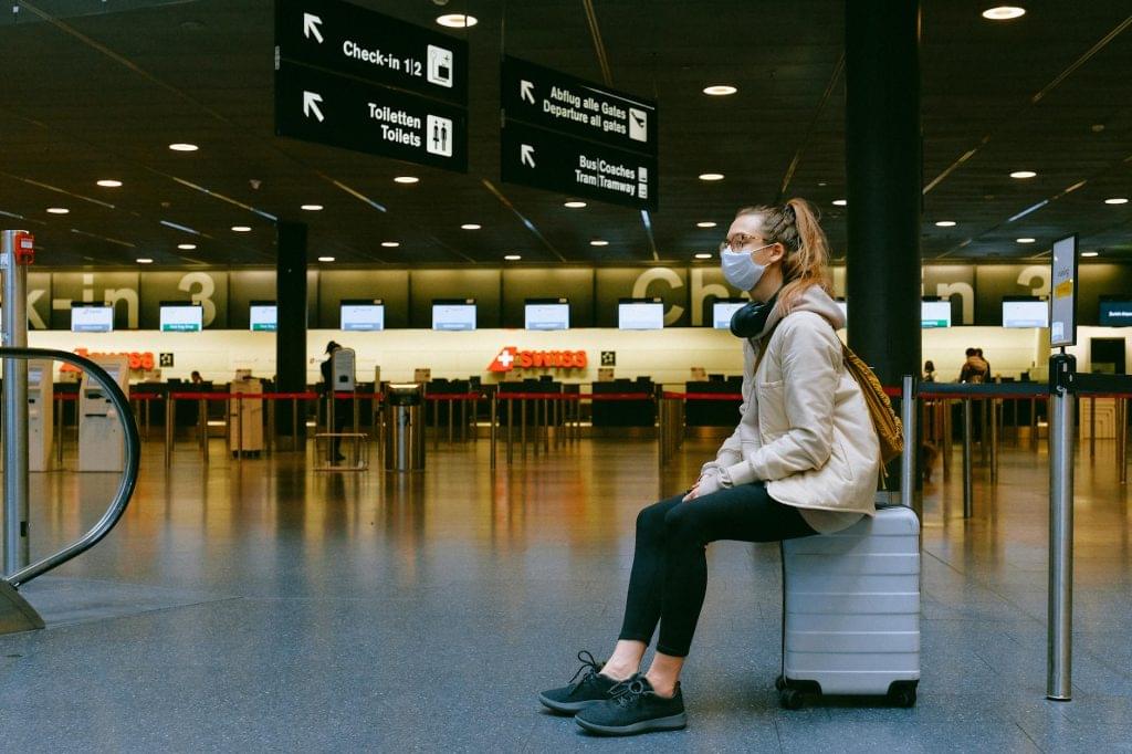 Health crisis and tourist behaviour - women sitting at the airport